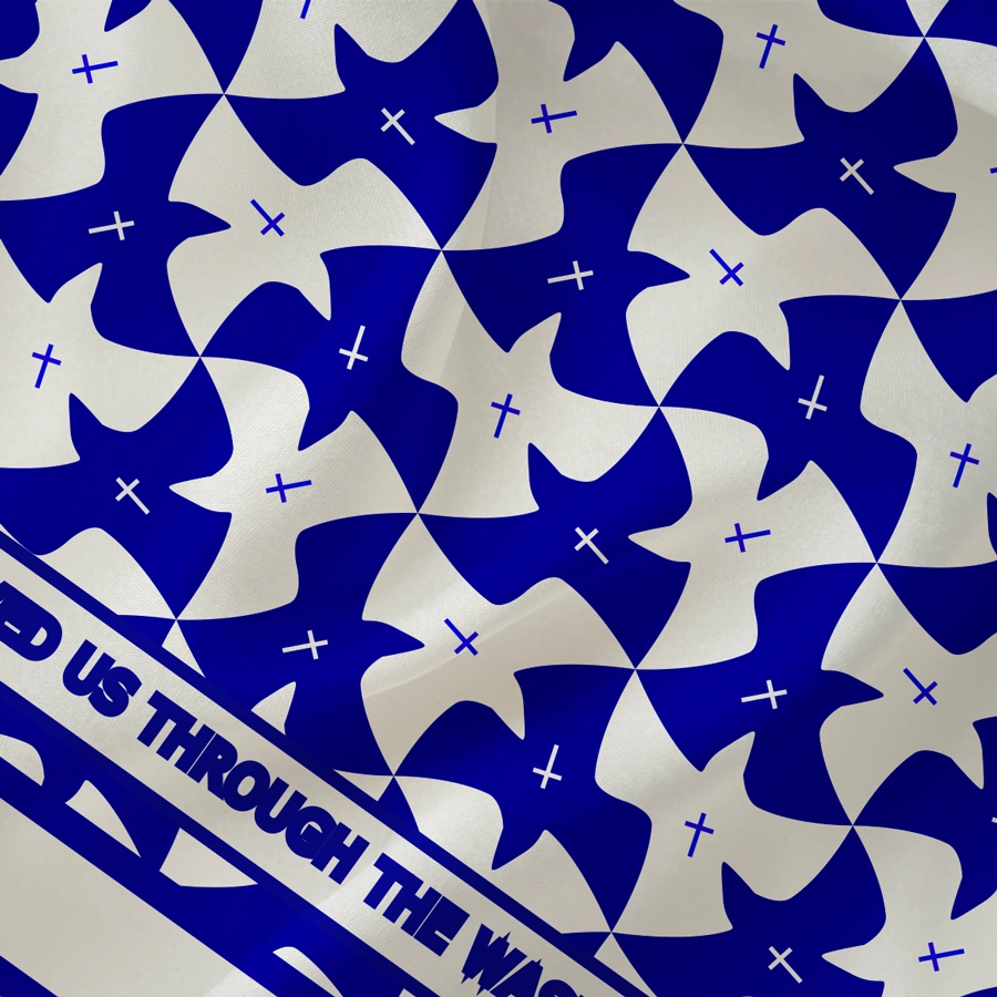 Blue and white patterned leso fabric featuring repeated dove and cross motifs. At the bottom, a Bible verse reads ‘He saved us through the washing of rebirth and renewal by the Holy Spirit. Titus 3:5.’ The design symbolizes peace, renewal, and spiritual grace by Evangelico for UndaMeta